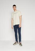 Tommy Jeans pánské béžové tričko LINEAR LOGO - XL (ACG)
